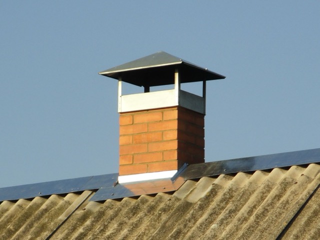 Chimney cap with storm collar on a metal flue — Gas Log Installation in Pinecrest, FL