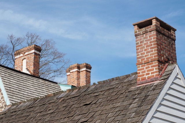 Home exterior with a brick chimney stack — Chimney Odor Removal in Pinecrest, FL